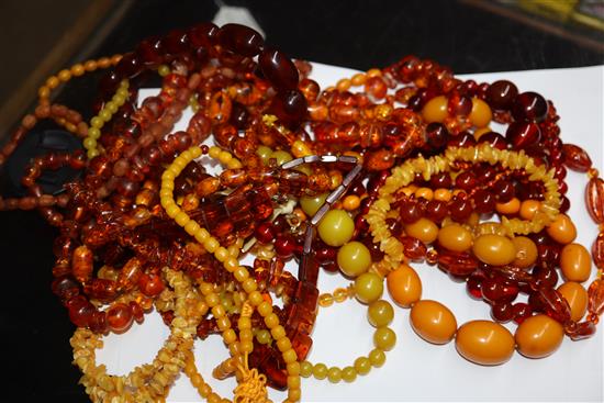 A quantity of amber and faux amber bead necklaces.